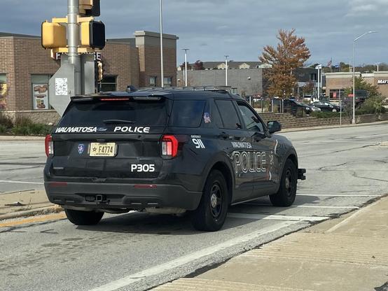 A Wauwatosa police car where the office is breaking the law.