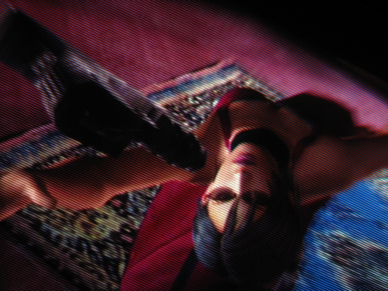 Gorgeously framed by a tastefully-placed blue rug, red-dressed Woman of Mystery Ada Wong whirlwind kicks her way into Resident Evil 4 with outrageous femininity.