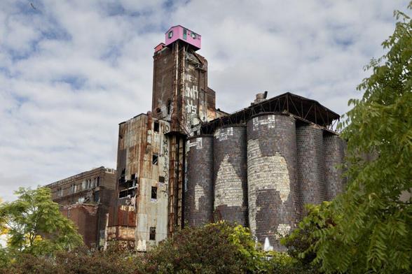the dilapidated former Canada Malting plant is seen with the iconic pink house atop it.